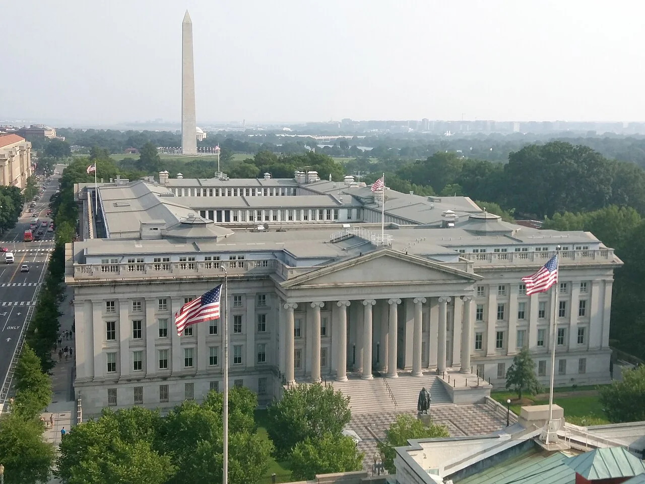 Photograph of the US Treasury building in Washington, DC. Washington Monument in the background.